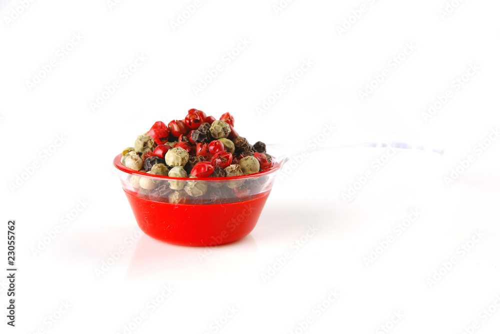 pepper in spoon on white pepper in spoon on white