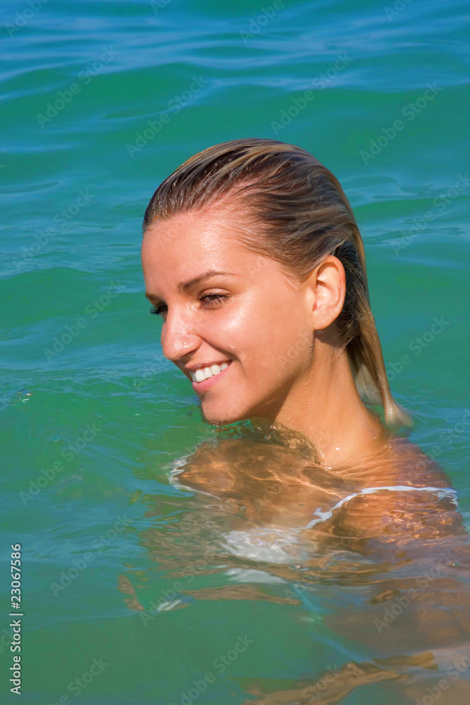 The sexual young girl swims in the sea