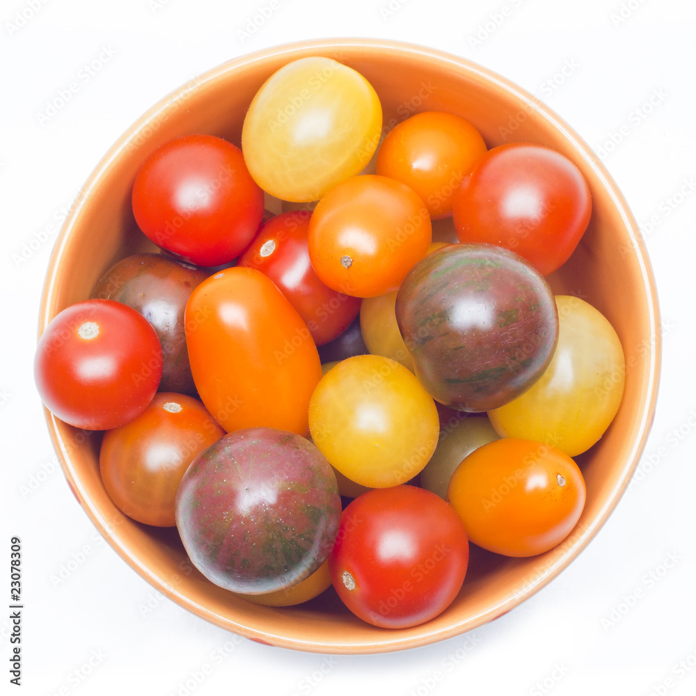 Different sorts of tomatoes served on a orange dish. Different sorts of tomatoes served on a orange dish.