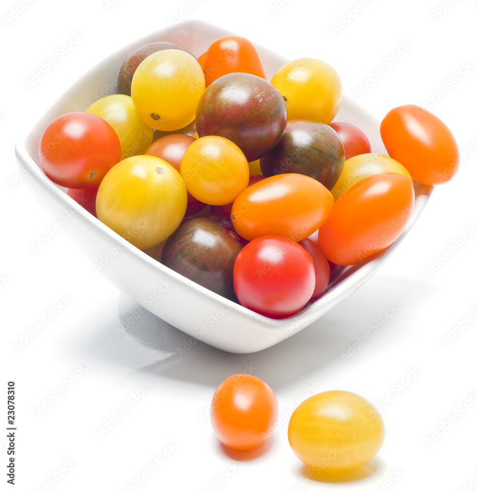 Different sorts of tomatoes served on a white dish. Different sorts of tomatoes served on a white dish.