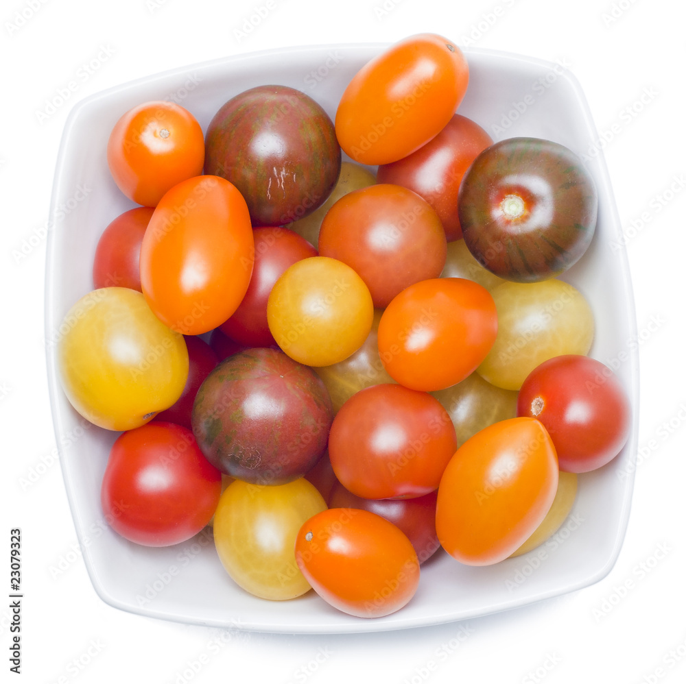 Different sorts of tomatoes served on a white dish. Different sorts of tomatoes served on a white dish.