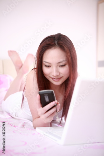 young asian sexy woman use laptop on bed