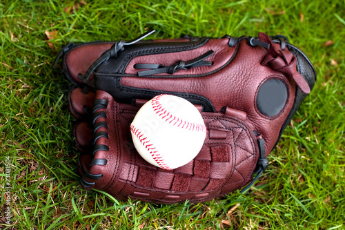 Baseball glove and ball on the grass