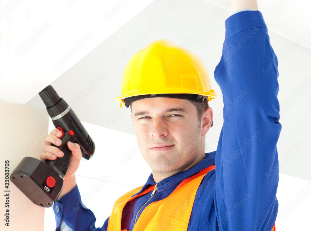 Joyful electrician repairing a power plan Joyful electrician repairing a power plan