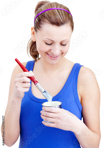 Happy woman using a paintbrush