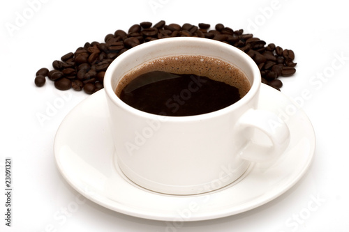 Black coffee in mug and coffee beans