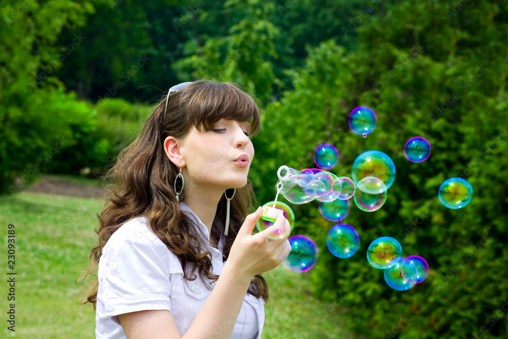 smile teen with soap bubbles in vivid green spring forest park smile teen with soap bubbles in vivid green spring forest park
