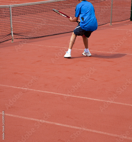 young tennis player hits theball