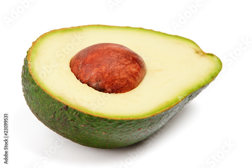 Half of avocado with pit isolated on white background