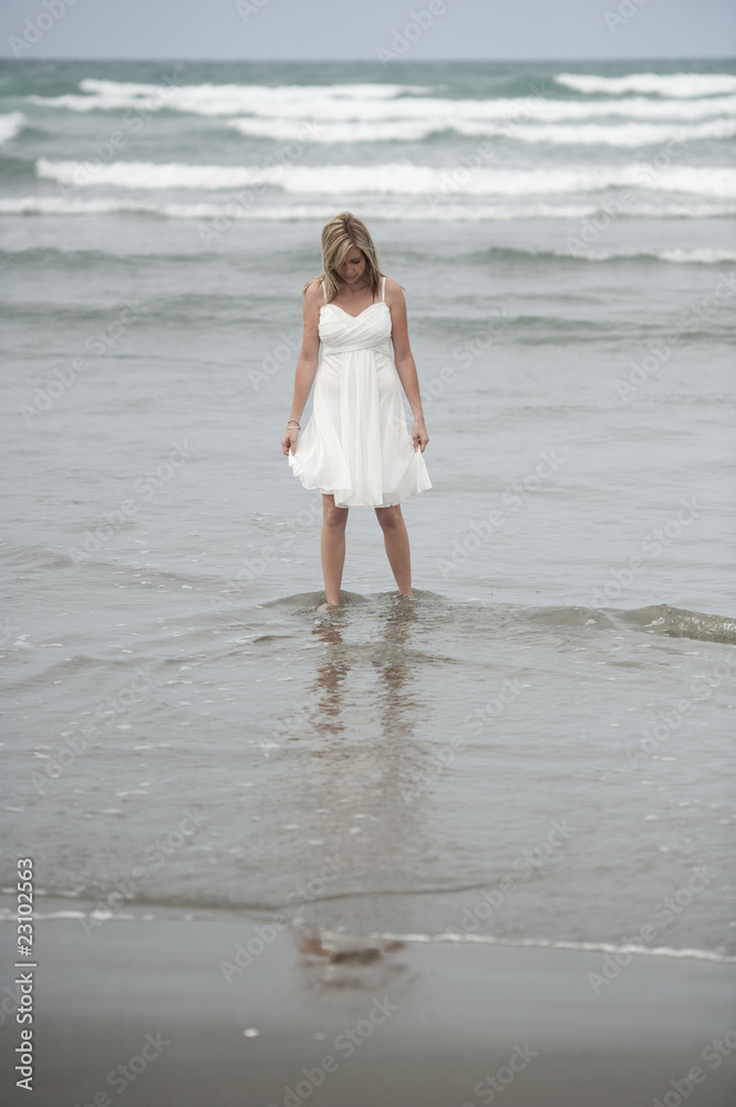 beautiful blonde teenage girl wading in sea beautiful blonde teenage girl wading in sea