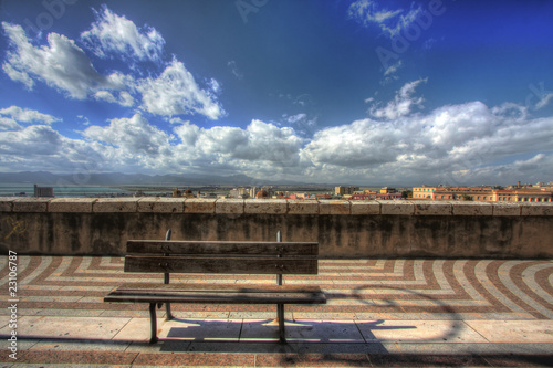 Bench with city view under a blue sky