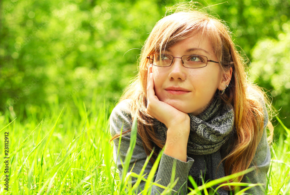 The girl lays on a grass