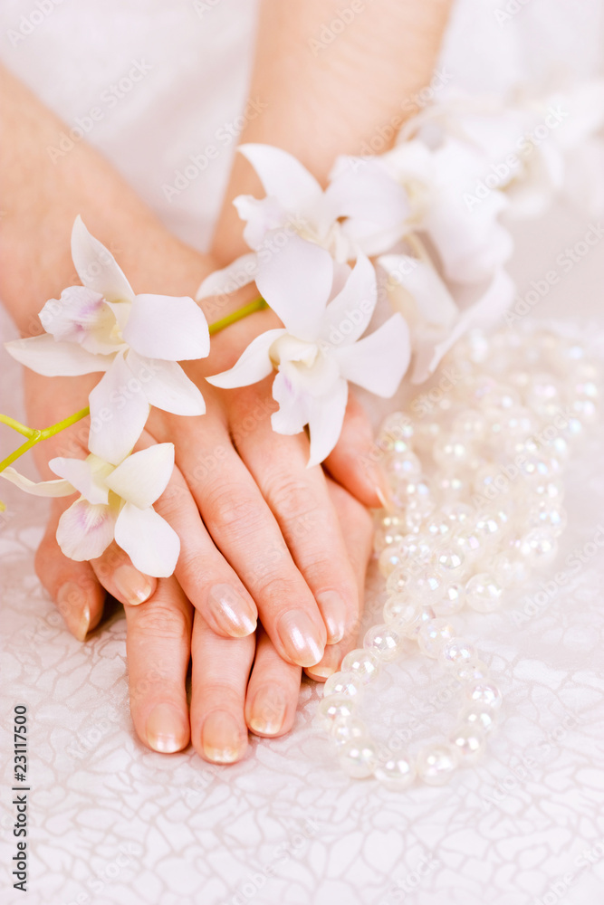 woman's hands, pearl beads and white orchid