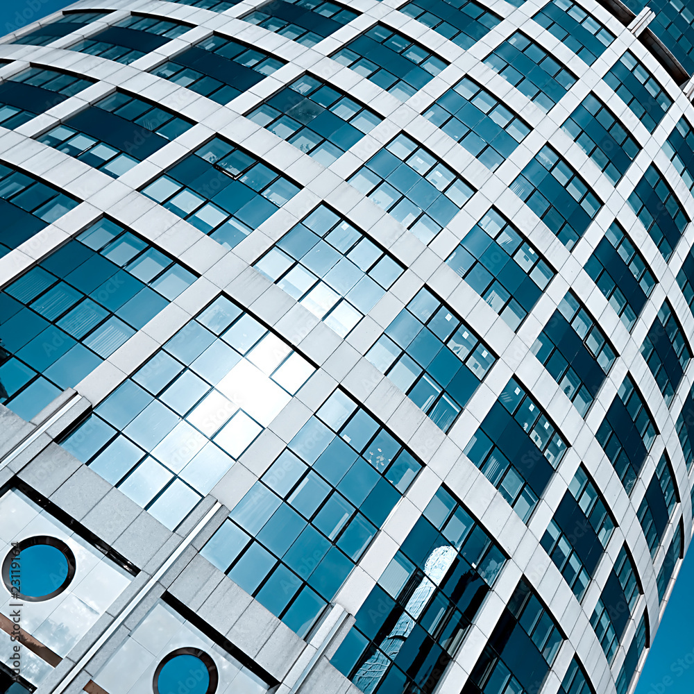 textured tower skyscraper with reflection of blue cloudless sky textured tower skyscraper with reflection of blue cloudless sky