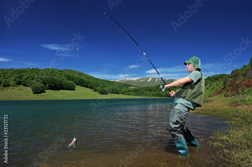 A fisherman fishing on a Mavrovo lake, Macedonia
