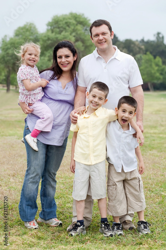 Happy couple with divine kids looking at you