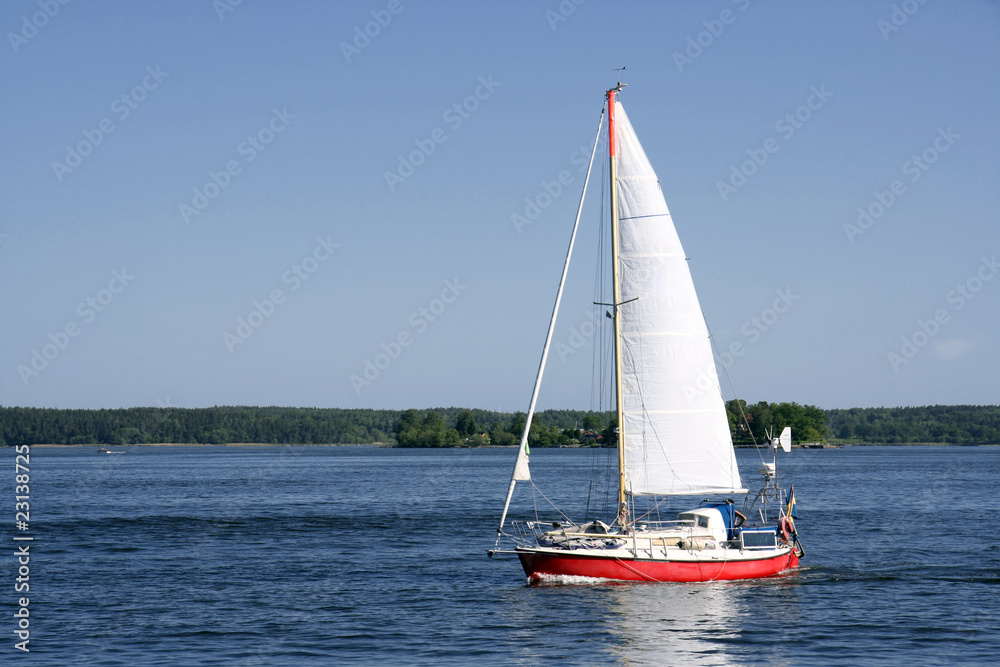 Sailing boat in blueand calm sea