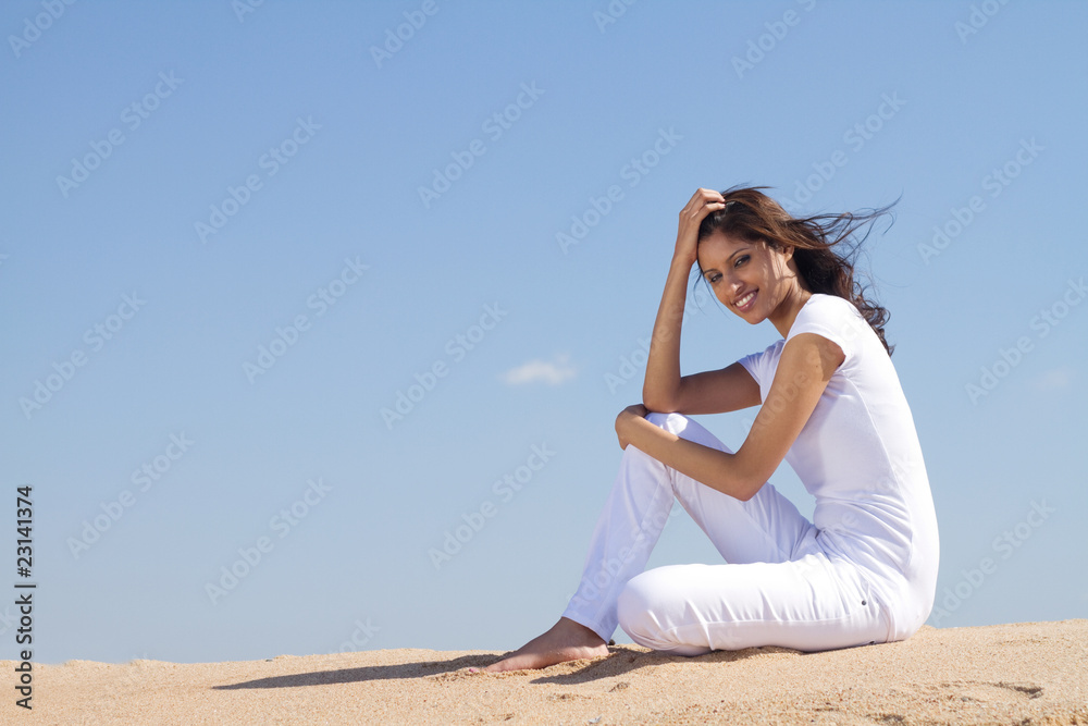 pretty woman sitting on beach