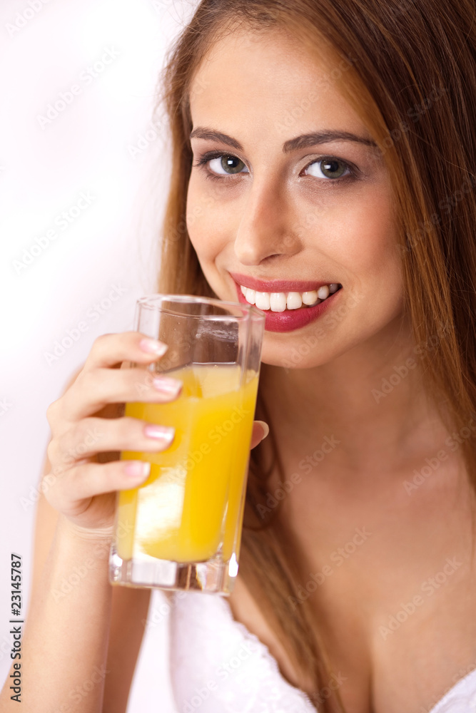 Close up shot of smiling young woman having orange juice Close up shot of smiling young woman having orange juice