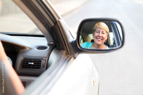 happy senior driving looking in side mirror © michaeljung