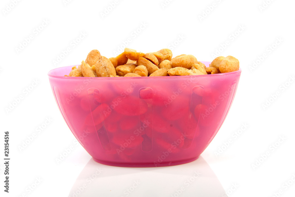 pink bowl with salted peanuts over white background pink bowl with salted peanuts over white background