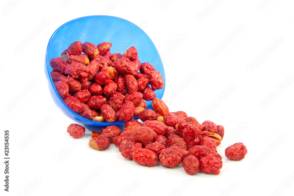 sugared peanuts fallen out of bowl over white background sugared peanuts fallen out of bowl over white background