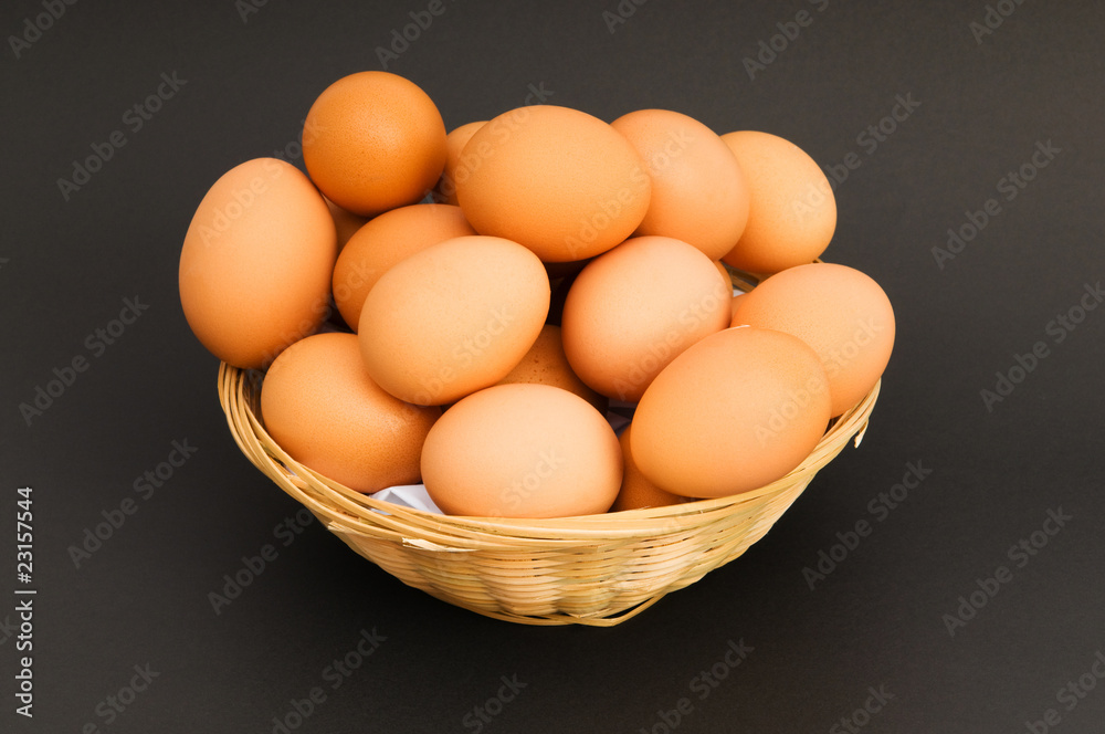 Basket of eggs on the colourful background Basket of eggs on the colourful background