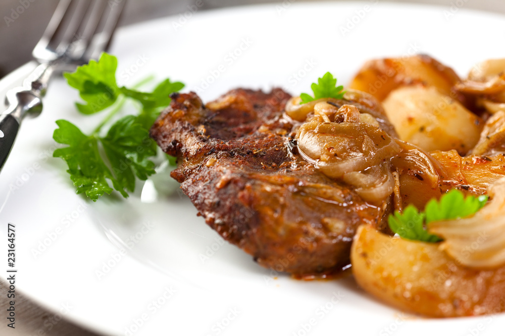 Braised pork chop with potatoes and onion in sauce Braised pork chop with potatoes and onion in sauce