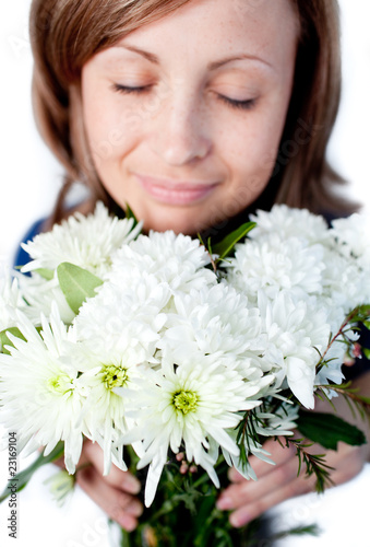Portrait of a delighted woman holding a bunch of flowers