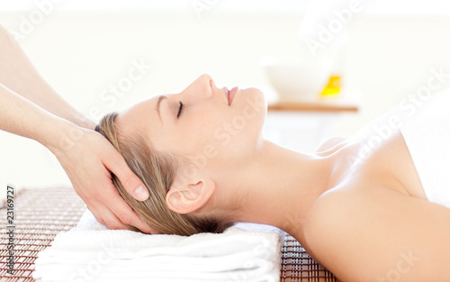 Close-up of a beautiful woman receiving a head massage