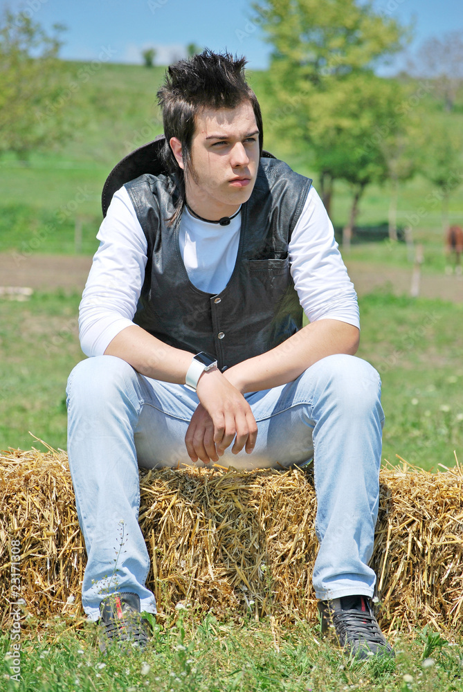 young man on hay bale young man on hay bale
