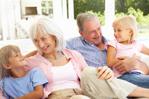 Portrait Of Grandparents With Grandchildren Relaxing Together