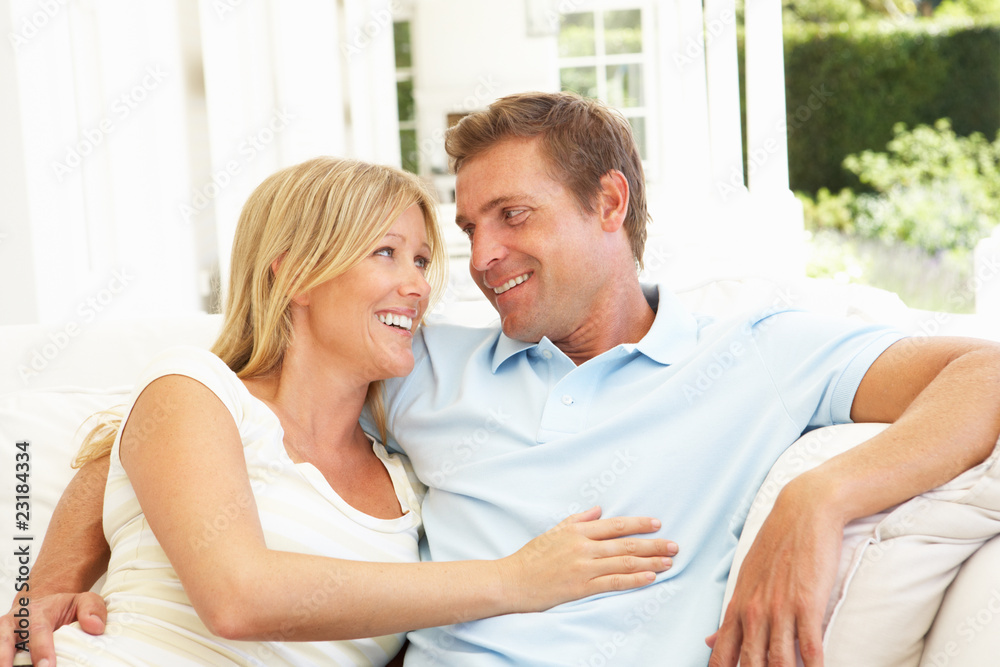 Portrait Of Young Couple Relaxing Together On Sofa Portrait Of Young Couple Relaxing Together On Sofa