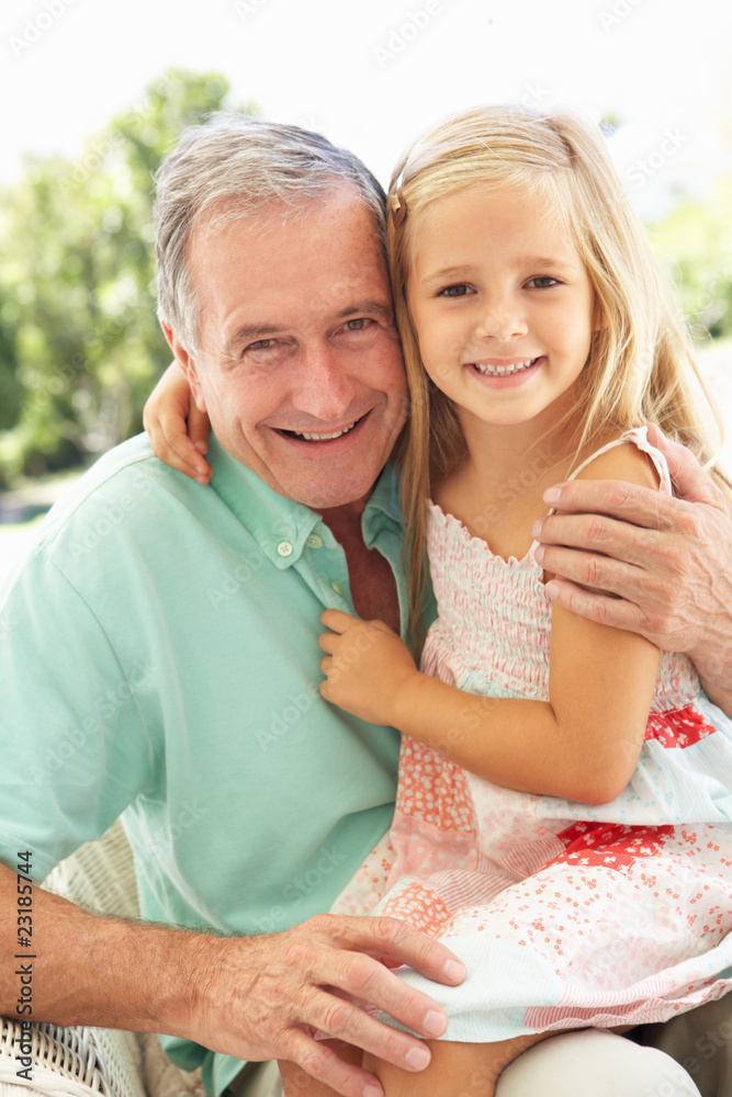Portrait Of Grandfather With Granddaughter Relaxing Together