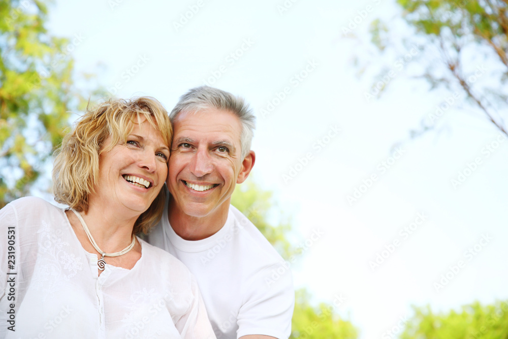 Mature couple smiling and embracing. Focus on the woman. Mature couple smiling and embracing. Focus on the woman.