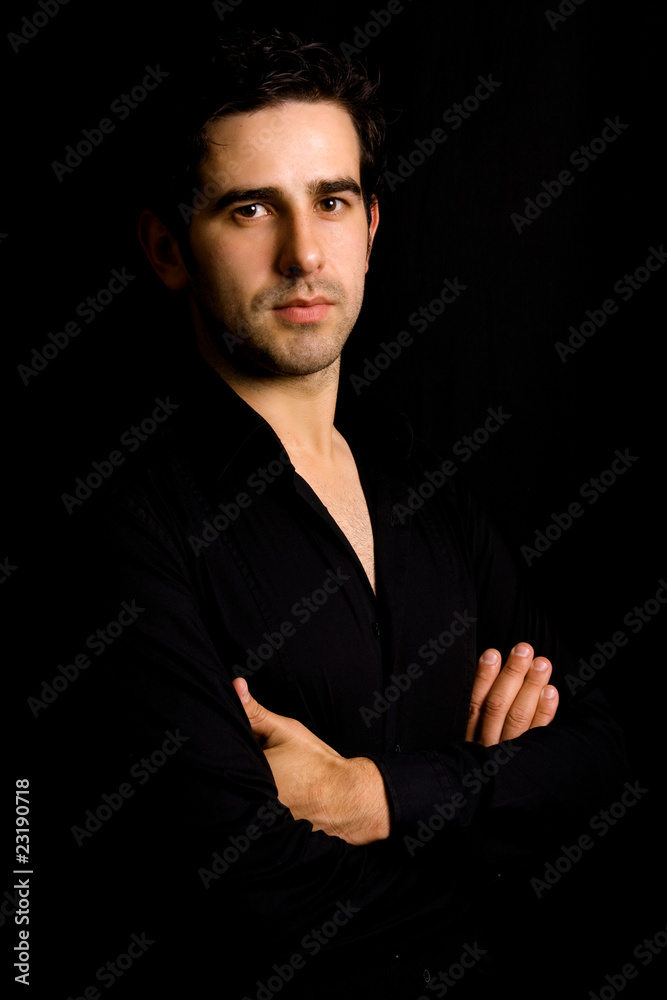 Portrait of young attractive man on a black background