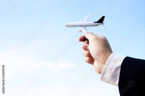 businessman playing with a toy plane