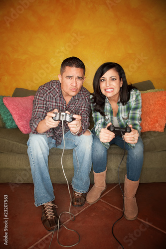 Hispanic Couple Playing Video game photo