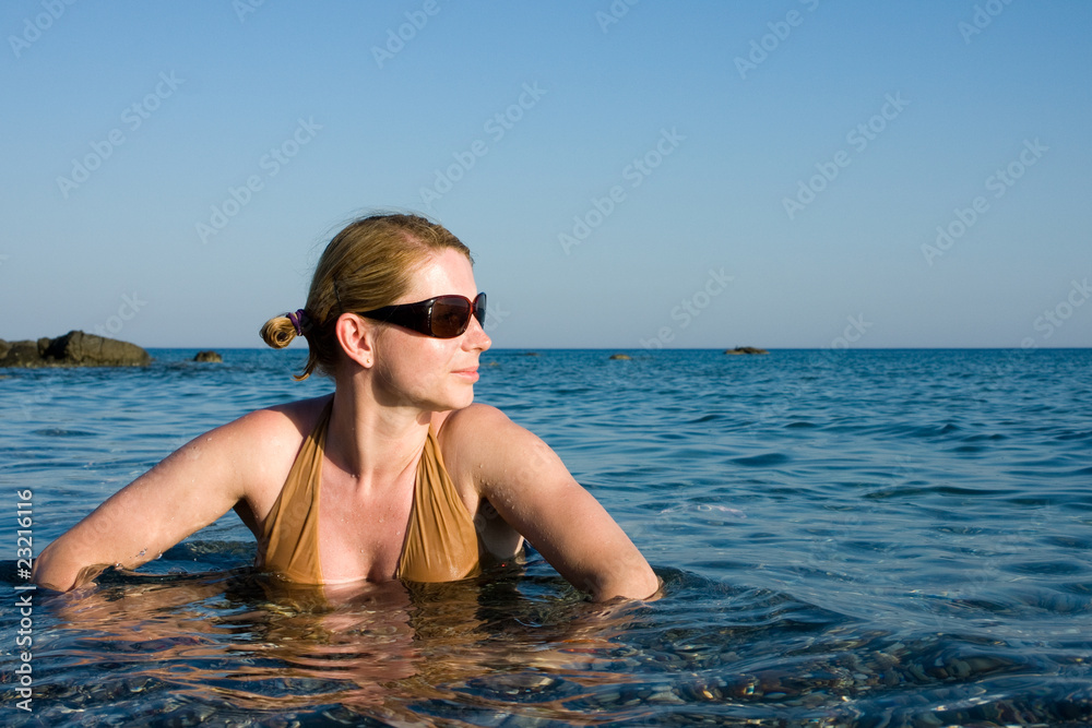 Portrait of young woman taking a bath in hot sea