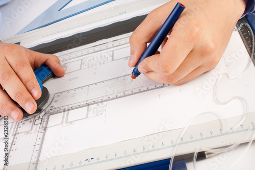 Architect working on architectural plans in the office