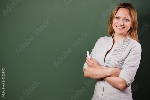 Fotografía smiling student or teacher at the blackboard