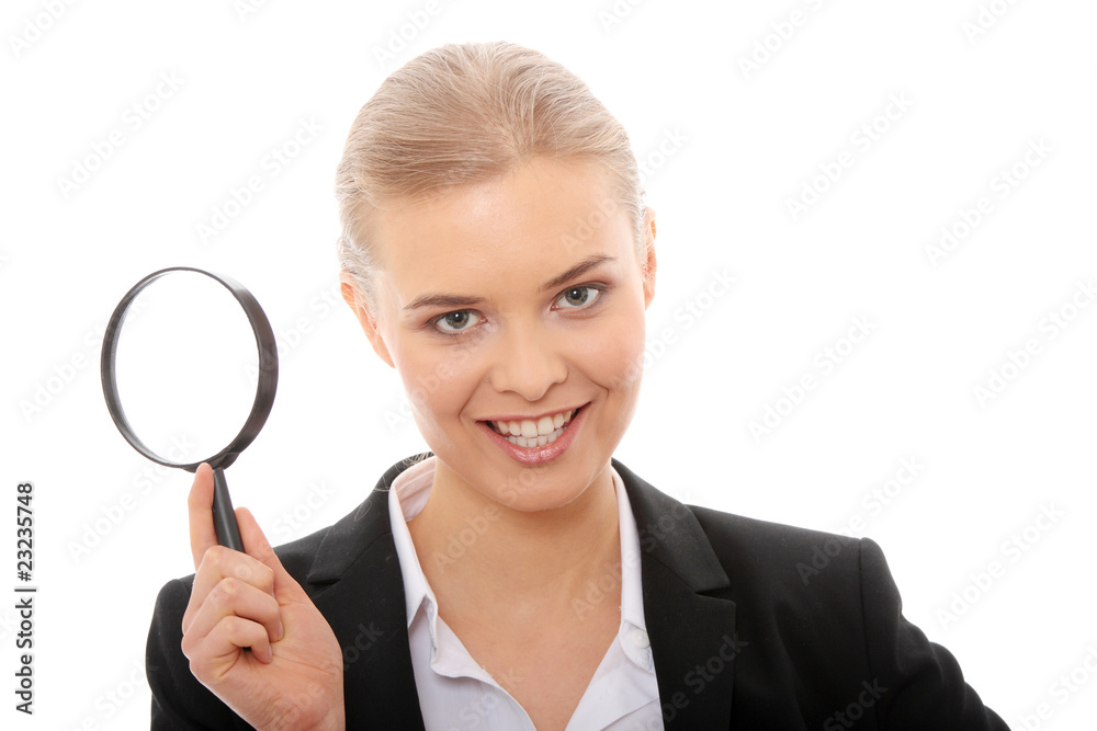 Business woman looking into a magnifying glass Business woman looking into a magnifying glass