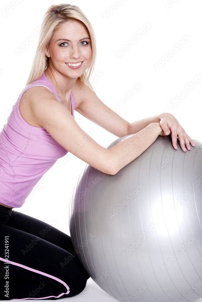 Young woman exercising on fitness ball Young woman exercising on fitness ball