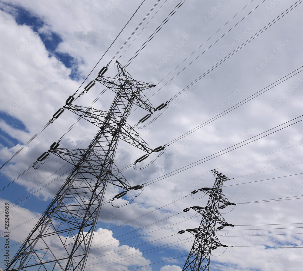 Electric power lines over blue and cloudy sky Electric power lines over blue and cloudy sky