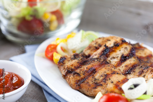 Marinated and grilled chicken breast with salad