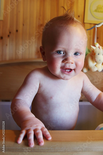 Sweet 6 month old Baby Boy Smiling in crib photo