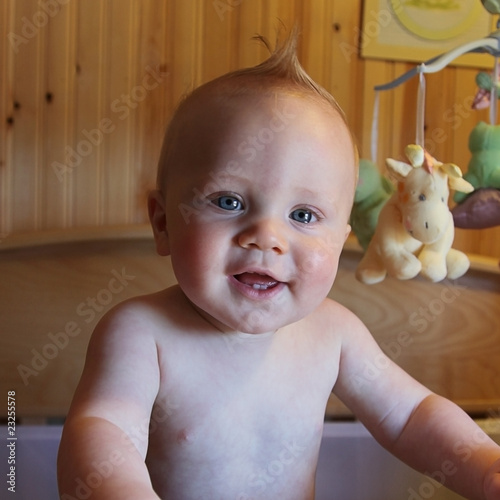 Sweet 6 month old Baby Boy Smiling in crib photo