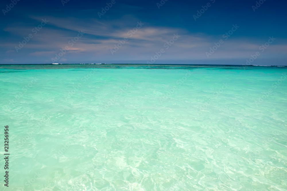 Cyan ocean under blue sky with clouds Cyan ocean under blue sky with clouds