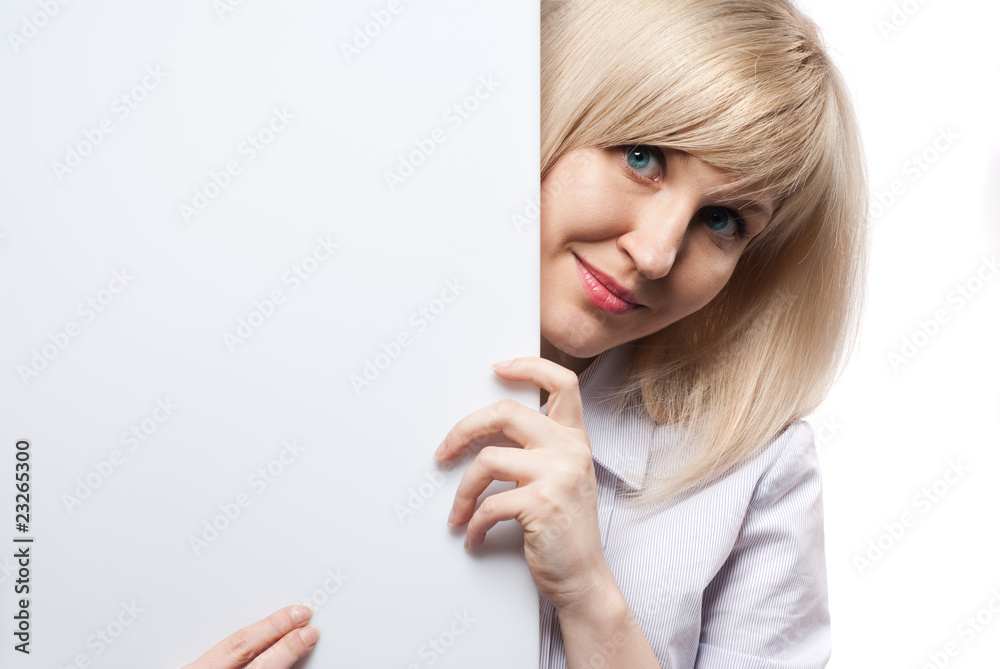 Attractive smiling woman holding white empty paper Attractive smiling woman holding white empty paper