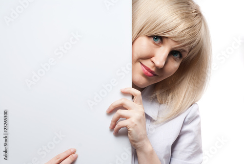 Attractive smiling woman holding white empty paper